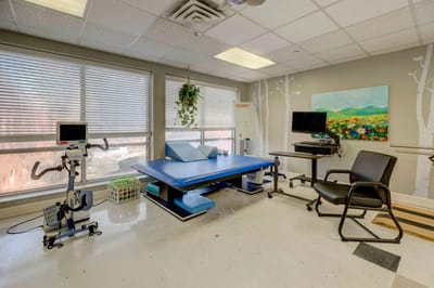 Rehabilitation room with equipment and natural light