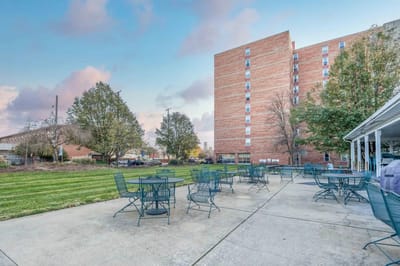 Outdoor seating area with the facility building in background