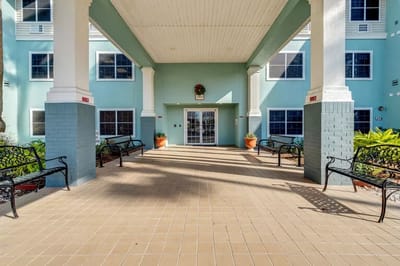A welcoming entrance area with benches and planters