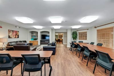Common area with seating and tables for residents