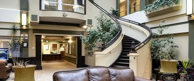 Lobby area with staircase and plants