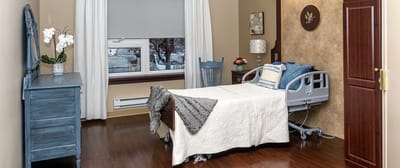 Comfortable private resident room with a hospital bed