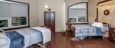 Private resident room with medical beds and natural light