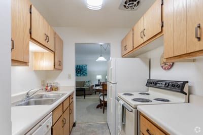 Clean kitchen with wood cabinets and appliances