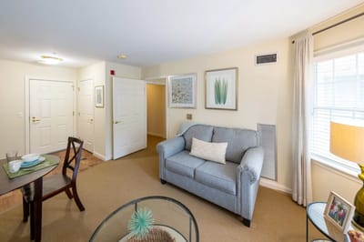 A bright, cozy resident room with furniture and decor