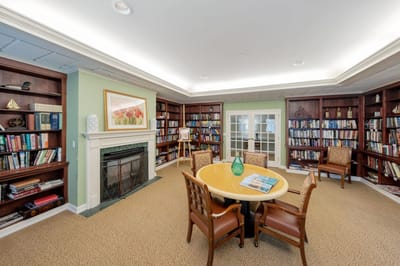 Cozy library area with bookshelves and a round table