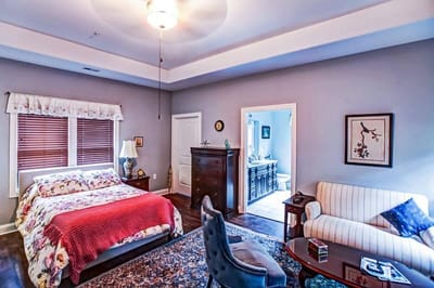 A cozy private resident room with a bed and seating area