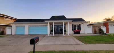 Exterior view of a residential building with blue garage doors