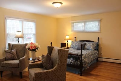 Cozy private room with a bed and armchairs