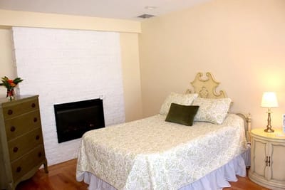Cozy private resident room with a bed and fireplace