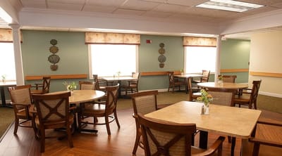 Bright dining area with tables and flowers