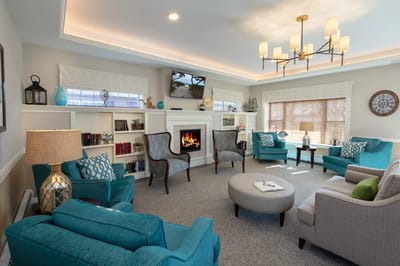 Bright common area with comfortable seating and a fireplace