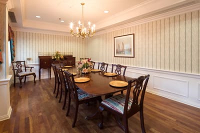 Elegant dining room with a chandelier and floral arrangement