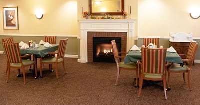 Dining room with tables set for a meal and fireplace
