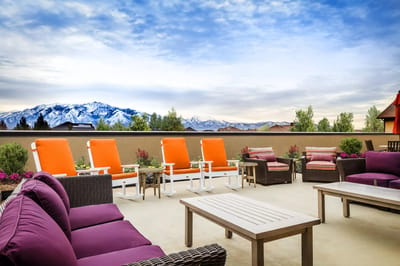 Outdoor lounge area with mountains in the background
