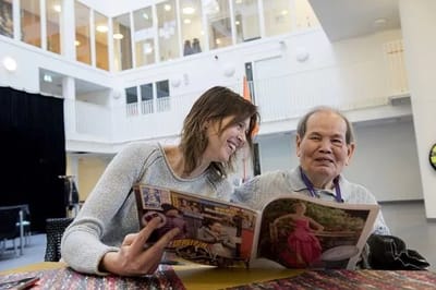 Residents enjoying a magazine in a common area