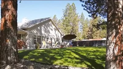 Exterior view of the facility's outdoor space with lawn and patio furniture
