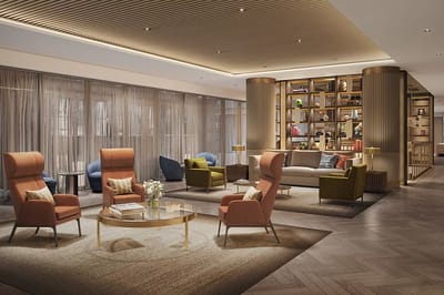 A stylish lobby area with seating and bookshelves