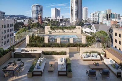 Rooftop pool and lounge area with city skyline