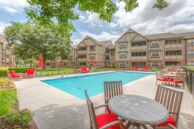 Outdoor pool area with seating and landscaping