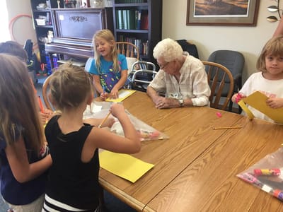 Residents engaging with children in an activity room