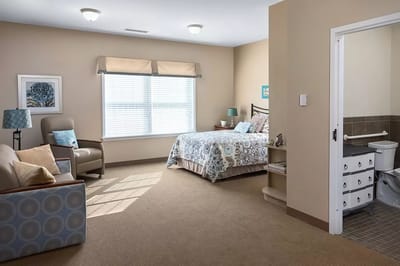 Bright and spacious resident room with bed and seating area