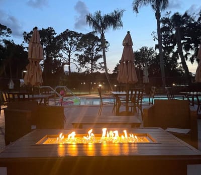 Outdoor pool area with a fire pit and seating
