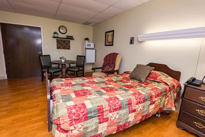 A comfortable resident room with furnishings