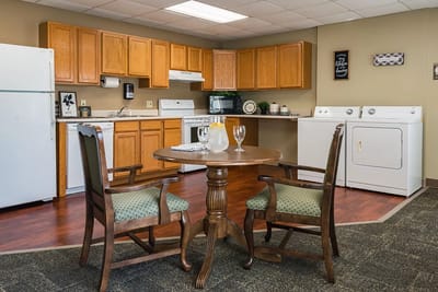 Bright kitchen area with dining table and appliances