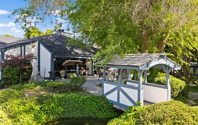 Charming outdoor space with a small bridge and patio