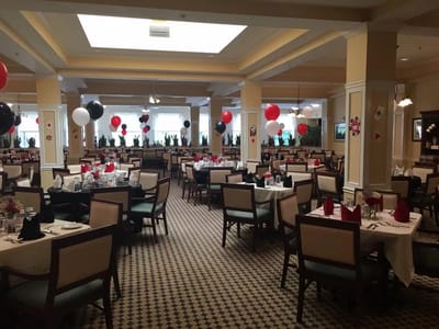 Dining room decorated for a celebration with balloons and table settings