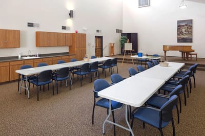 Bright activity room with tables and chairs