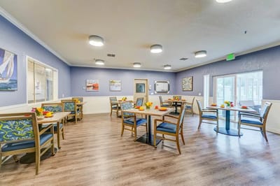 Bright dining room with tables set for a meal
