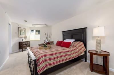 Interior view of a furnished room with a bed and decor