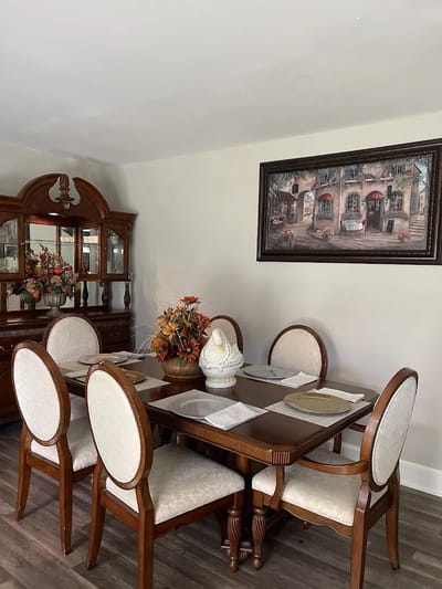 Well-decorated dining room with a floral centerpiece