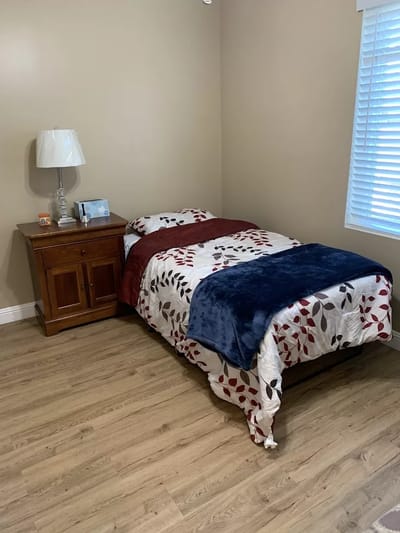 Cozy resident room with bed and nightstand