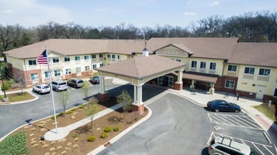 Aerial view of the building exterior with landscaped entrance