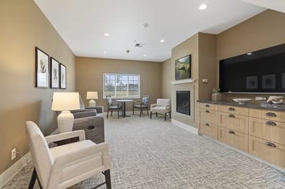 Bright common area with seating and a fireplace