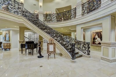 Elegant lobby featuring a grand staircase and piano