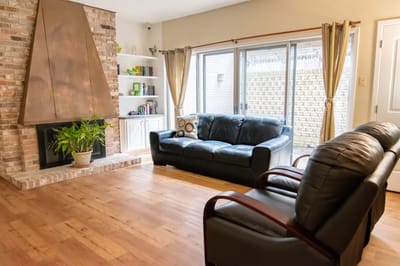 Cozy living room with leather sofas and a fireplace