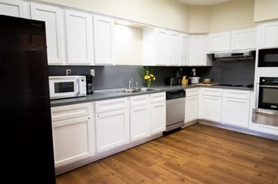 Bright, modern kitchen area with white cabinetry