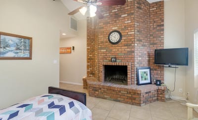 Cozy interior of a resident room with brick fireplace