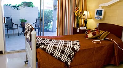 Cozy resident room with bed and patio access