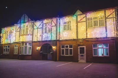 Exterior of the facility decorated with colorful lights