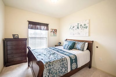 Cozy bedroom setup with floral decor and natural light