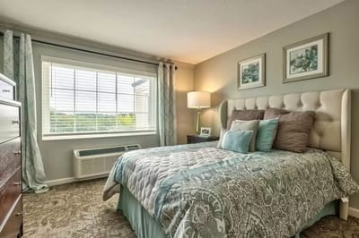 Cozy bedroom with a bed and decorative window