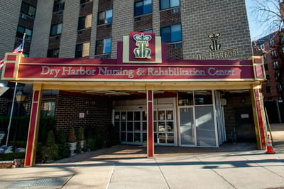 Exterior view of Dry Harbor Nursing & Rehabilitation Center entrance