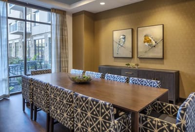 Bright dining area with a large table and artwork