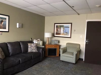 A cozy lounge area with seating and artworks