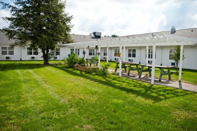 Outdoor space with picnic seating and garden beds